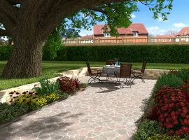 Gartenecke mit Tisch, Stühlen und gepflastertem Gartenweg