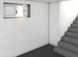 Keller mit weißen Wänden und einer grauen Treppe