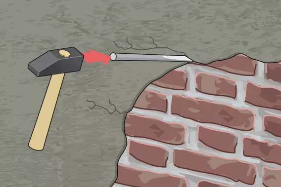 Abbildung eines Hammers und Meißels, mit denen der Altputz vom Untergrund entfernt wird - Fassade selbst sanieren